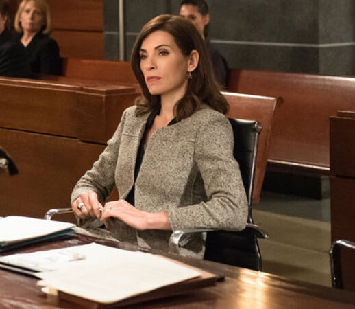 A woman sits confidently in a courtroom, ready to present her case.