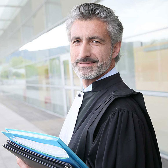 Confident male lawyer holding legal files outdoors.
