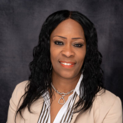 Professional woman with long black hair and a beige blazer smiling. Professional woman with long black hair and a beige blazer smiling.