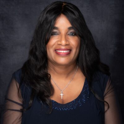 Smiling woman with long black hair and a cross necklace. Smiling woman with long black hair and a cross necklace.